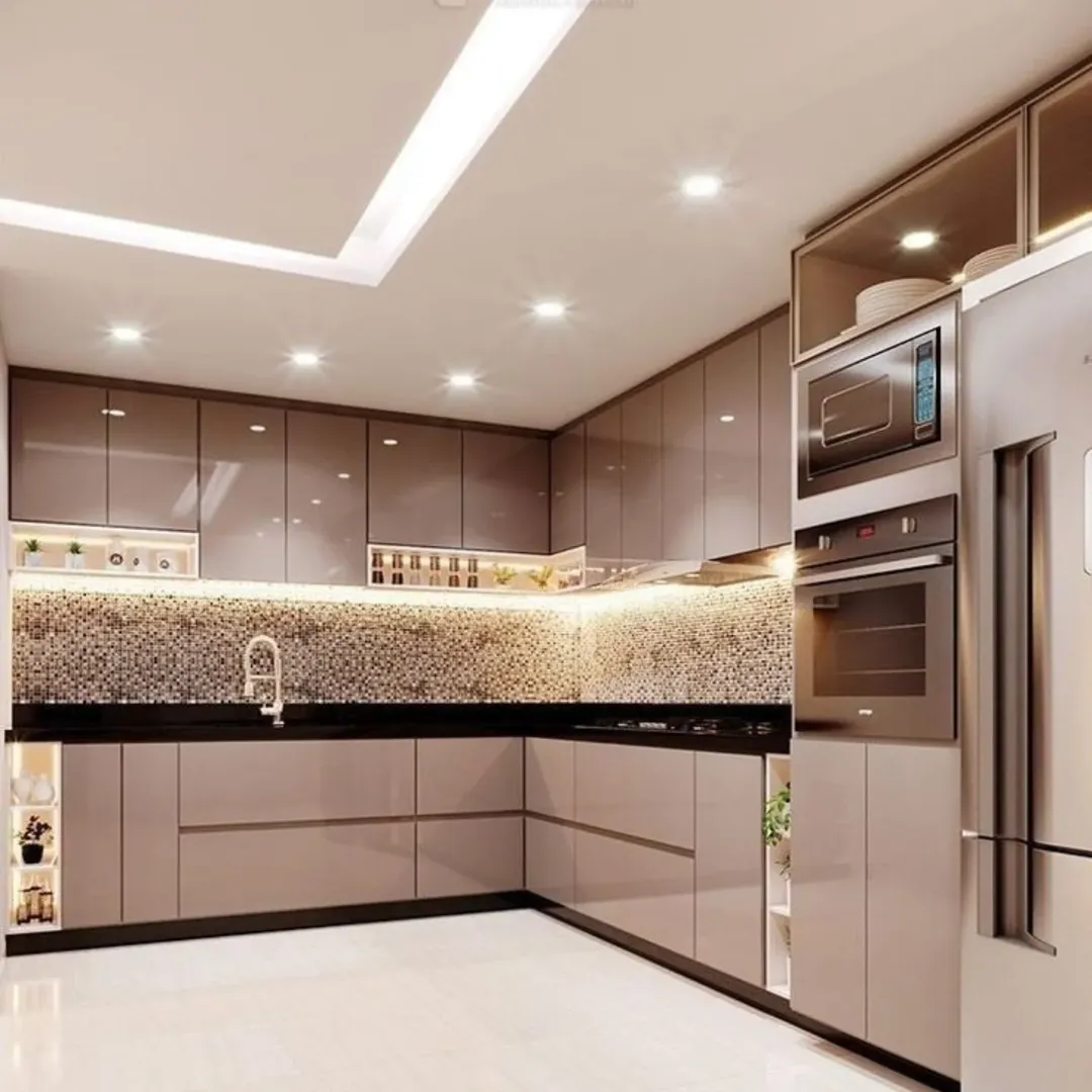 Modern kitchen with glossy taupe cabinets, mosaic tile backsplash, built-in appliances, under-cabinet lighting, and a stainless steel refrigerator—perfect inspiration for kitchen color ideas and stunning kitchens following kitchen trends 2025.