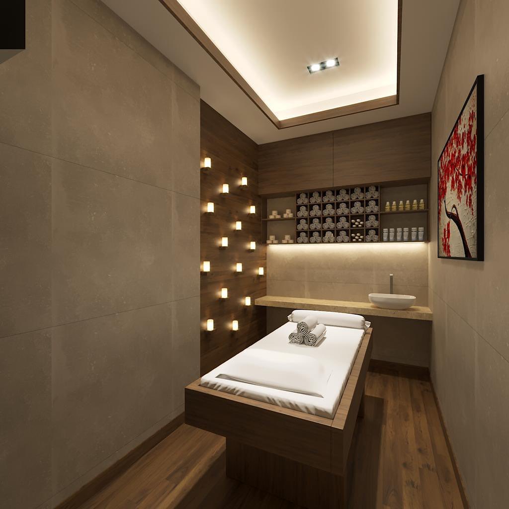 A modern massage room featuring a massage table, rolled towels, wall-mounted shelves with products, soft lighting, and a decorative painting—perfect inspiration for those seeking stylish massage room ideas.