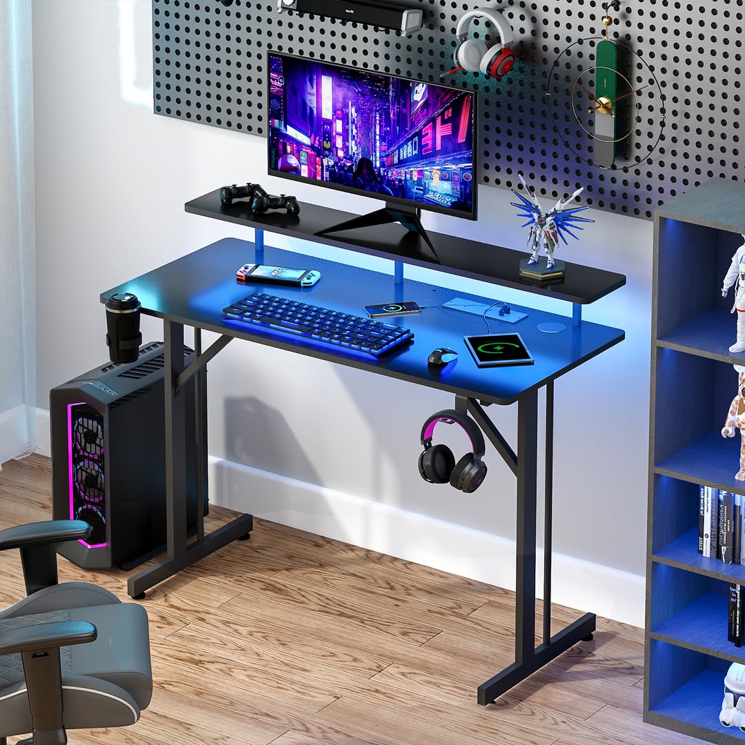 A modern computer desk design features a monitor, keyboard, mouse, headphones, and computer tower illuminated by blue LED lights, next to a shelf and a pegboard with accessories—perfect for those seeking inspiring desk ideas.
