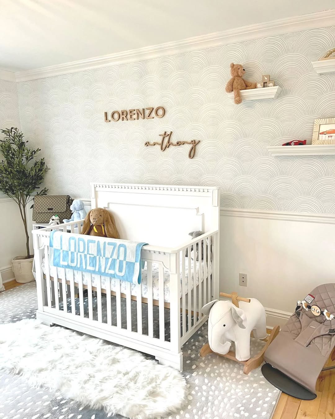 A bright nursery with a white crib, a personalized