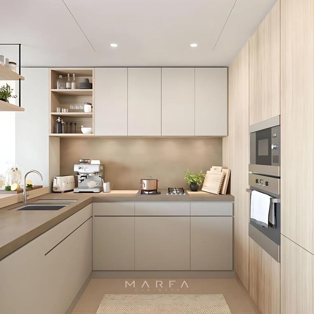 Modern kitchen with light wood cabinets, built-in oven, electric stove, coffee machine, open shelves, and beige countertops. Showcasing Kitchen Design Trends and Stunning Kitchen Colors for 2025, perfect for an inviting space.
